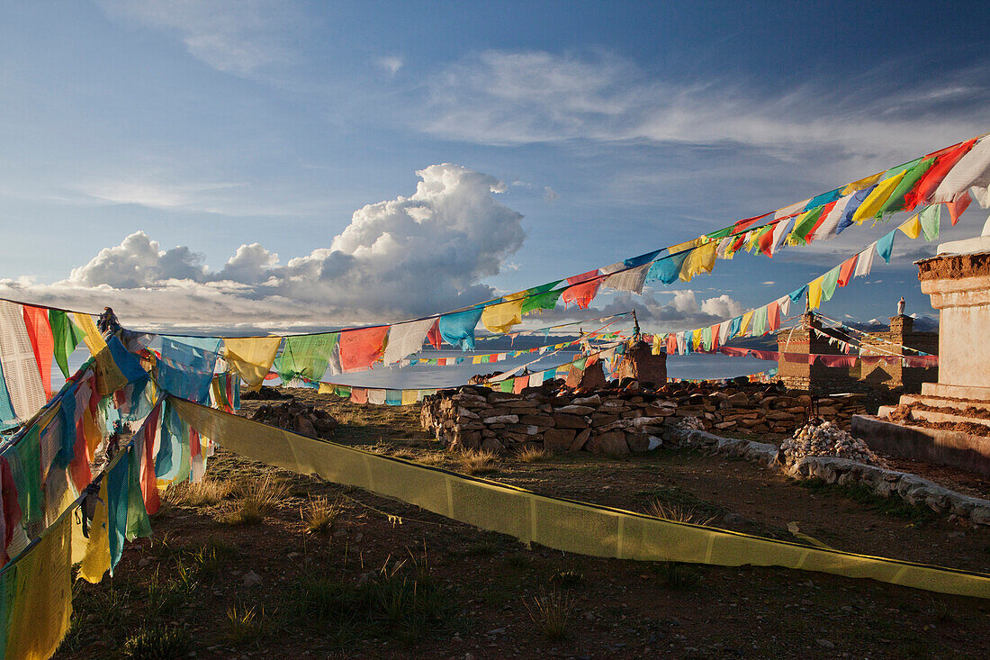 View of Lake Manasarovar from Chiu Monastery. Prayer flags hung in long rows from buildings. A buddhist temple and monastery on the lake shore., Lake Manasarovar, Tibet Autonomous Region