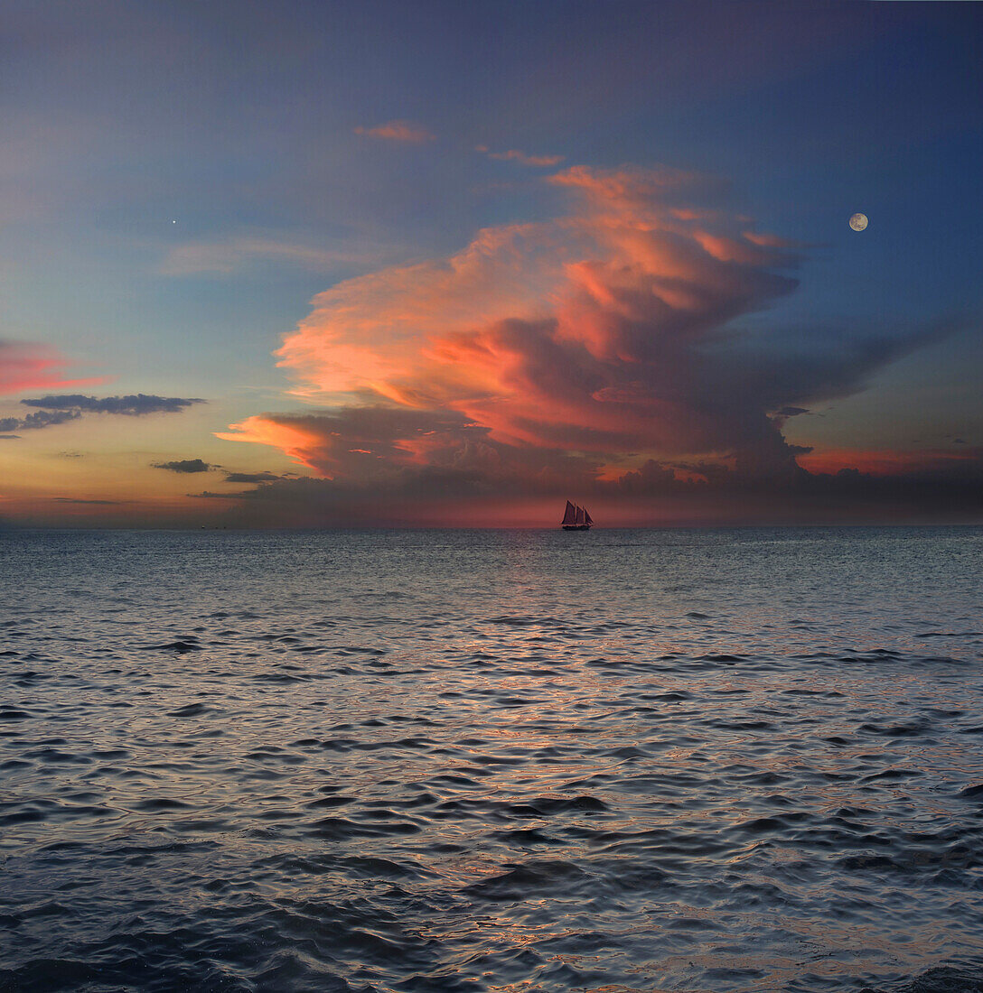 View of sloop on the horizon at sunset, Boracay, Philippines, Asia