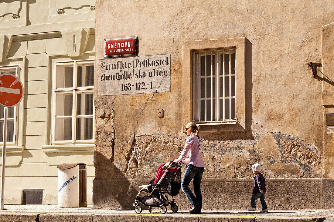 Mother and child walking along the old walls of Prague below Castle Hill, Prague, Czech Republic