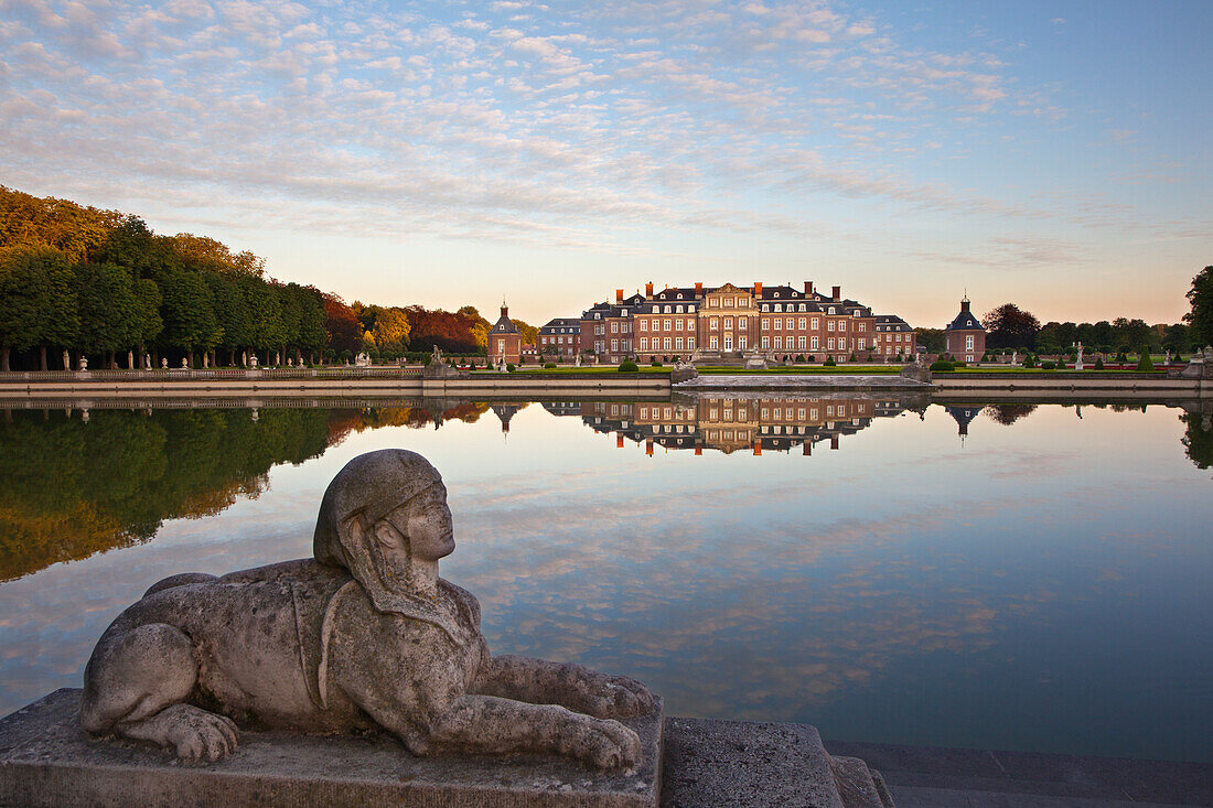 Sphinx at the stairs of the pond at dusk, Nordkirchen moated castle, Muensterland, North Rhine-Westphalia, Germany, Europe