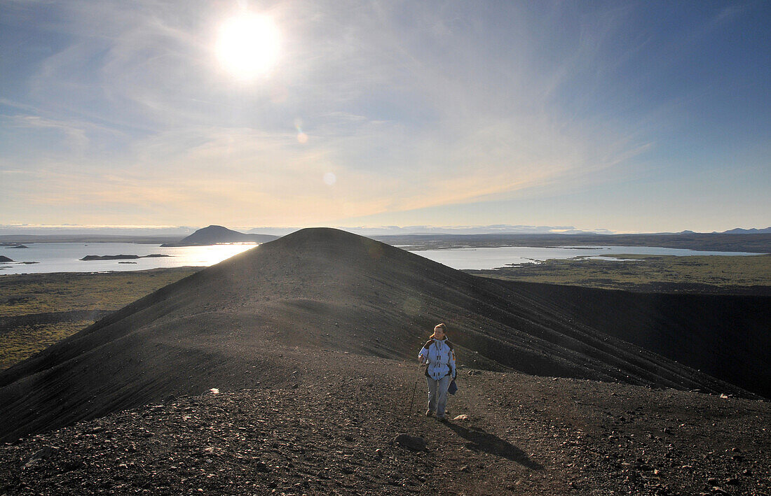 Hiker on Hverfel vulkano near lake Myvatn, Skutustadir, Nordurland eystra, Iceland