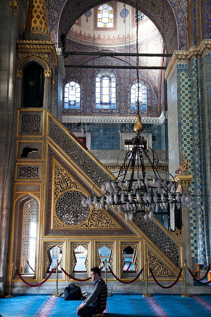 Turkey,Istanbul,Man Preying in the Arpaciliar Mosque also known as The New Mosque