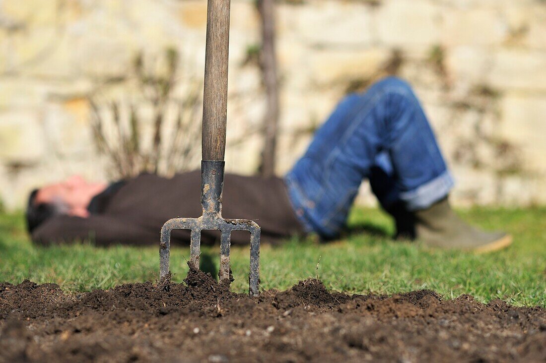 Close-up of a man taking some rest after digging around