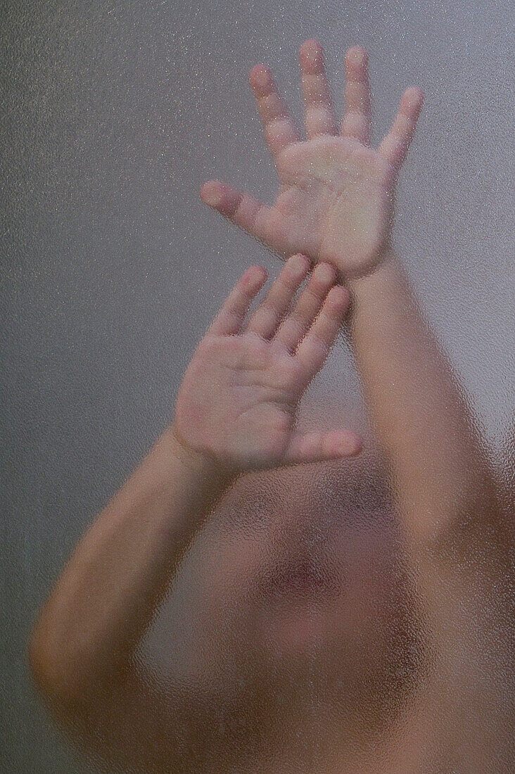 Child's Hands Pressed Against Shower Glass