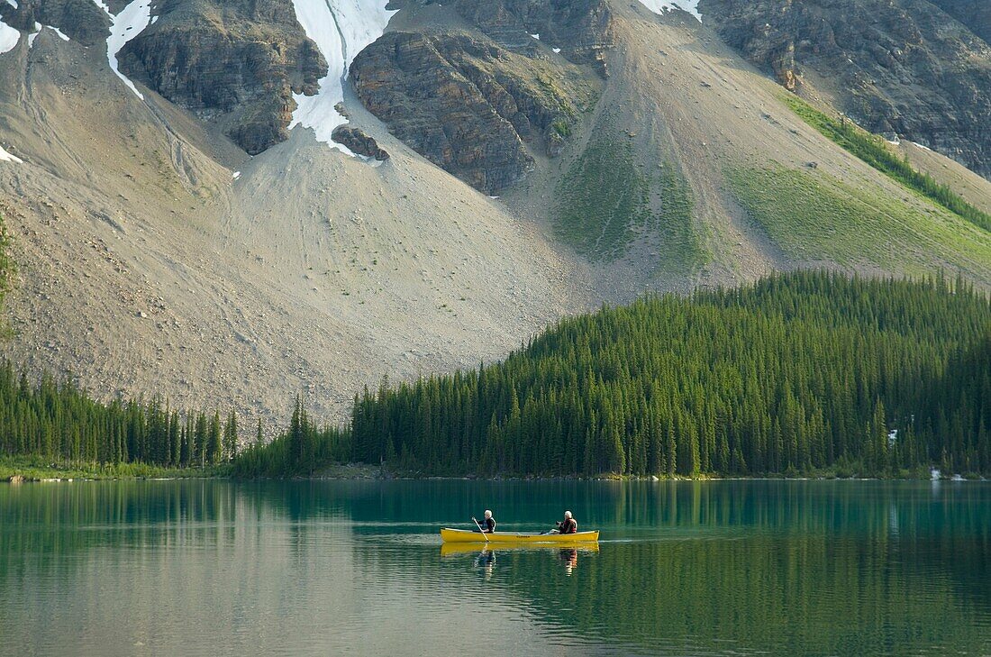 Canoeists paddling on Moraine Lake, Banff National Park Alberta Canada