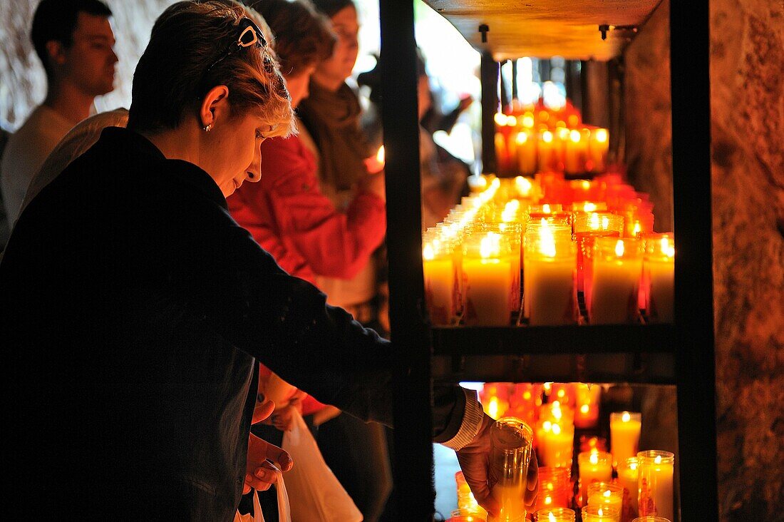 Spain, Asturias, Picos de Europa National Park, Covadonga, Pilgrims lighting candles near the shrine of the virgin Mary   Legend has it that in the 8th century, the Virgin blessed Asturian Christian forces with a well-timed signal to attack Spain´s Mooris