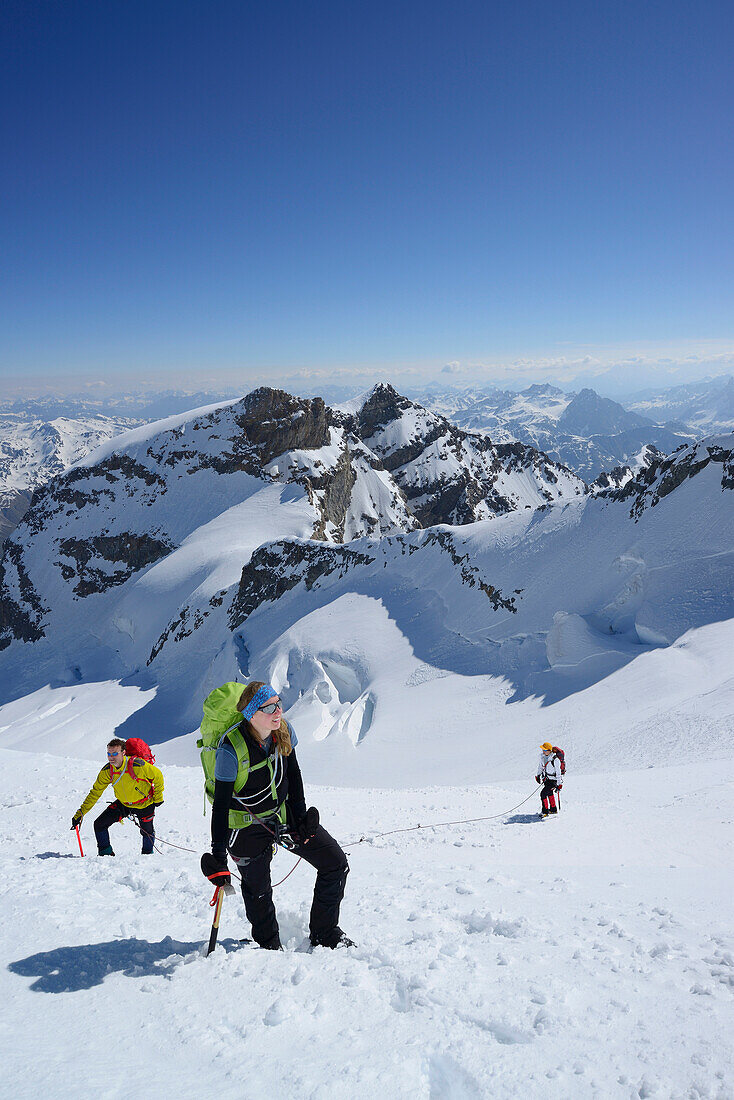 Three mountaineers ascending to Piz Palue, Grisons, Switzerland