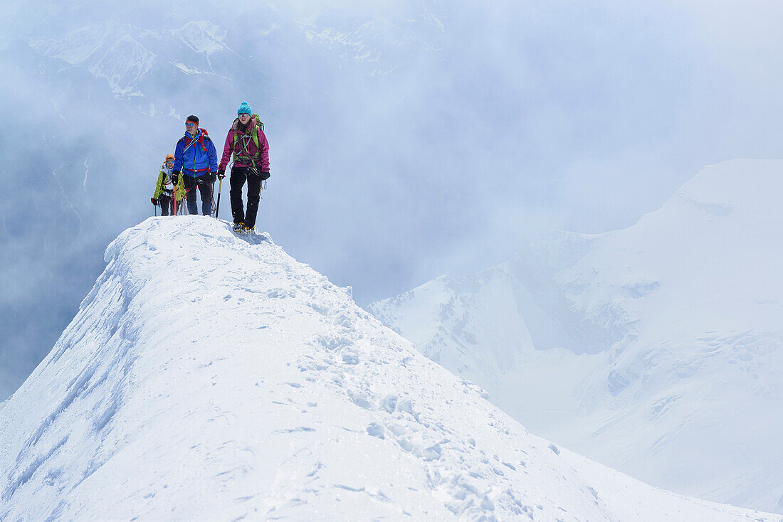 Three mountaineers ascending to Piz Palue, Grisons, Switzerland