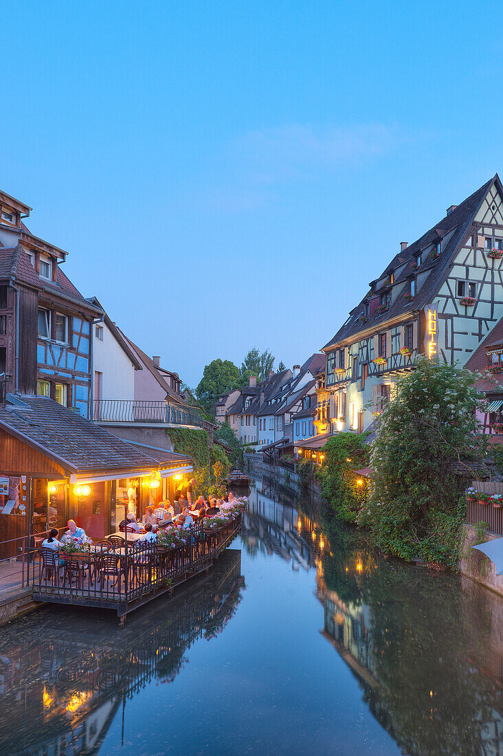 Restaurant and half timbered houses at the Lauch river in the evening, Little Venice, Colmar, Alsace, France, Europe