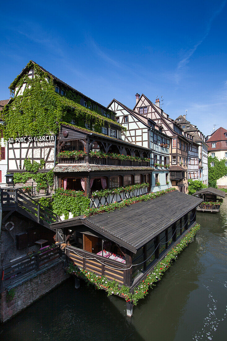 Restaurant Au Pont St. Martin and half timbered houses along the canal in La Petite France district, Strasbourg, Alsace, France, Europe