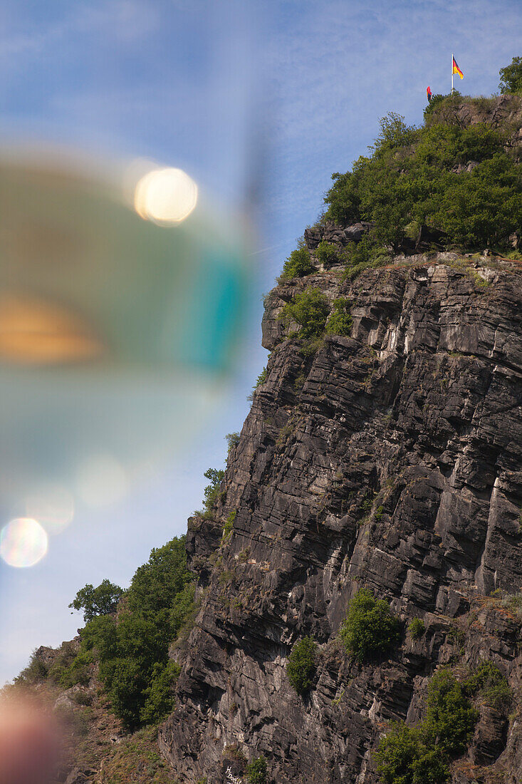 The Loreley Rock and a glass of wine seen from Rhine river cruise ship MS Bellevue, Sankt Goarshausen, Rhineland-Palatinate, Germany, Europe