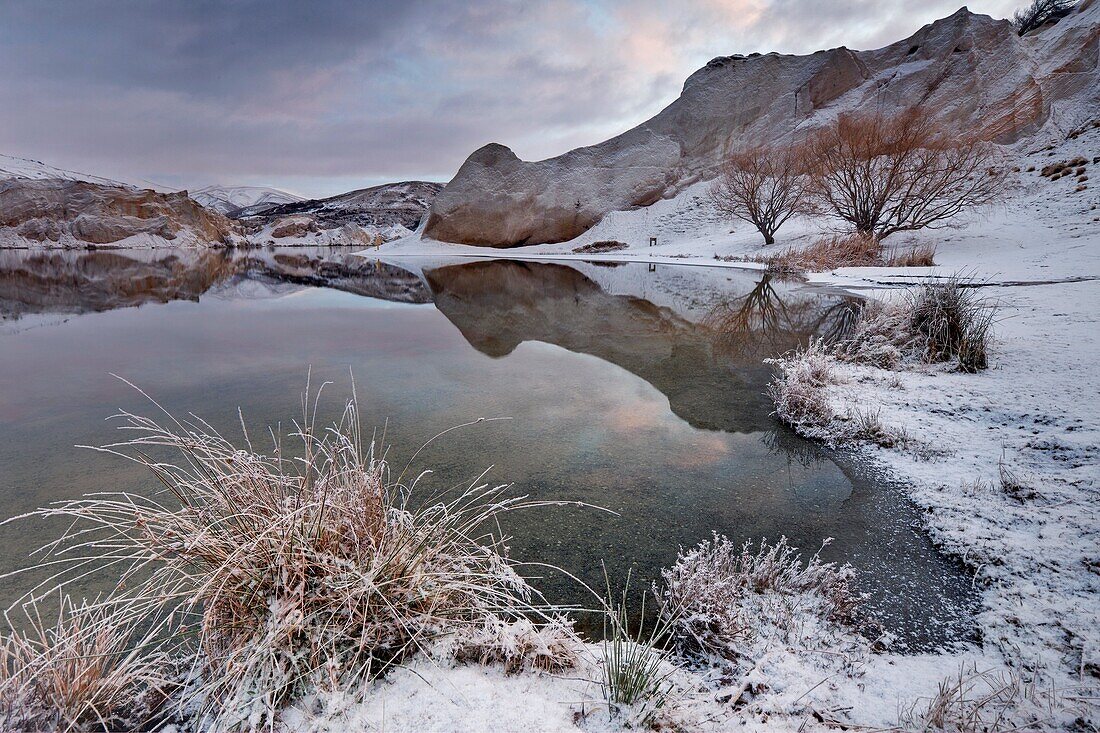 Winter dawn reflection, Blue Lake, St Bathans historic goldfields town, Central Otago, New Zealand