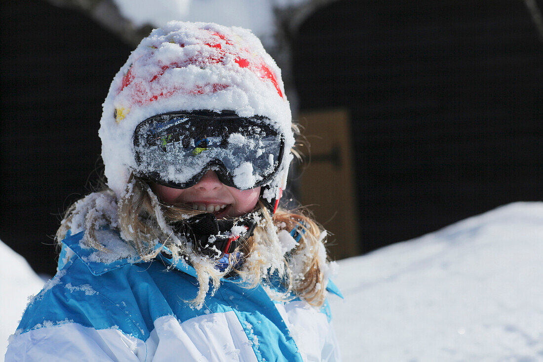 Snow-covered girl wearing ski googles, Gargellen, Montafon, Vorarlberg, Austria