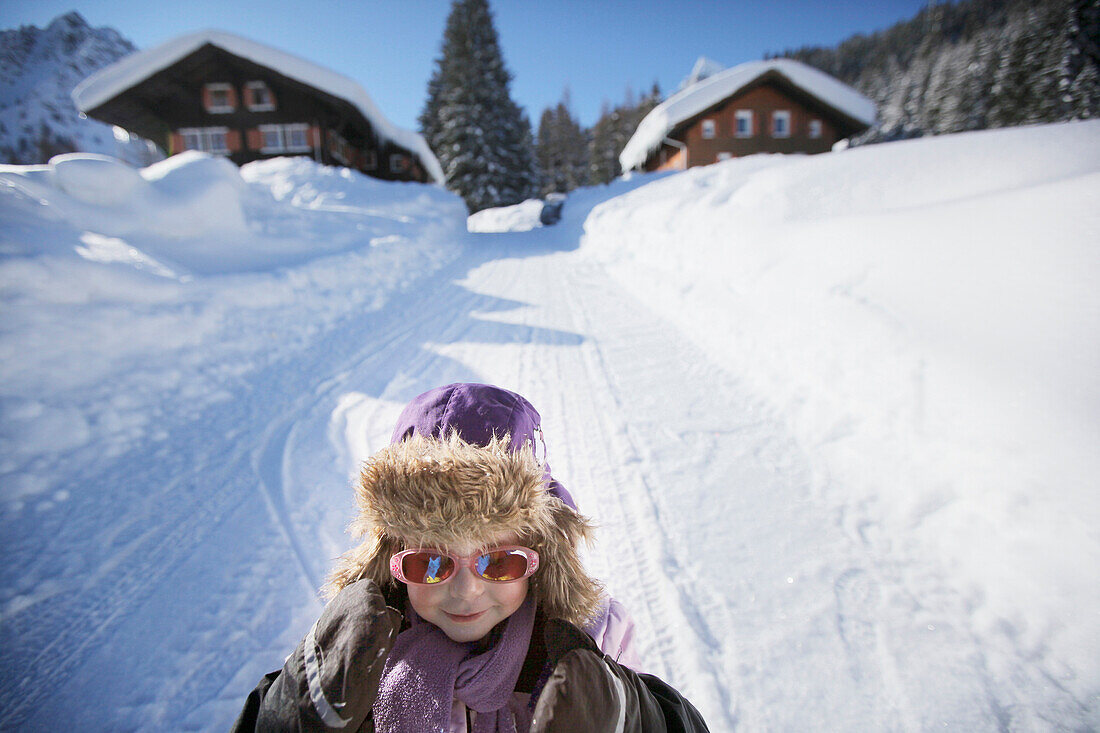 Mädchen (3 Jahre) fährt Schlitten, Gargellen, Montafon, Vorarlberg, Österreich