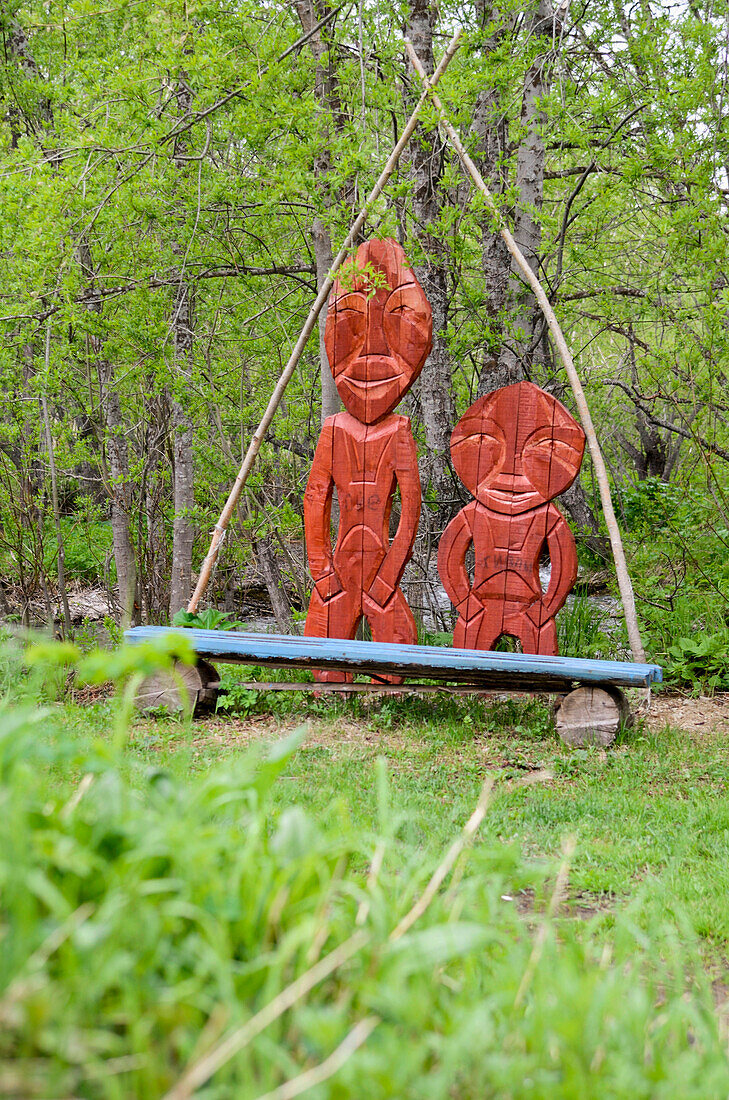 Wooden sculptures of aboriginal people, natives, in an Itelmen village, Pimtschach, Itelmens, Kamtschatka, Russia