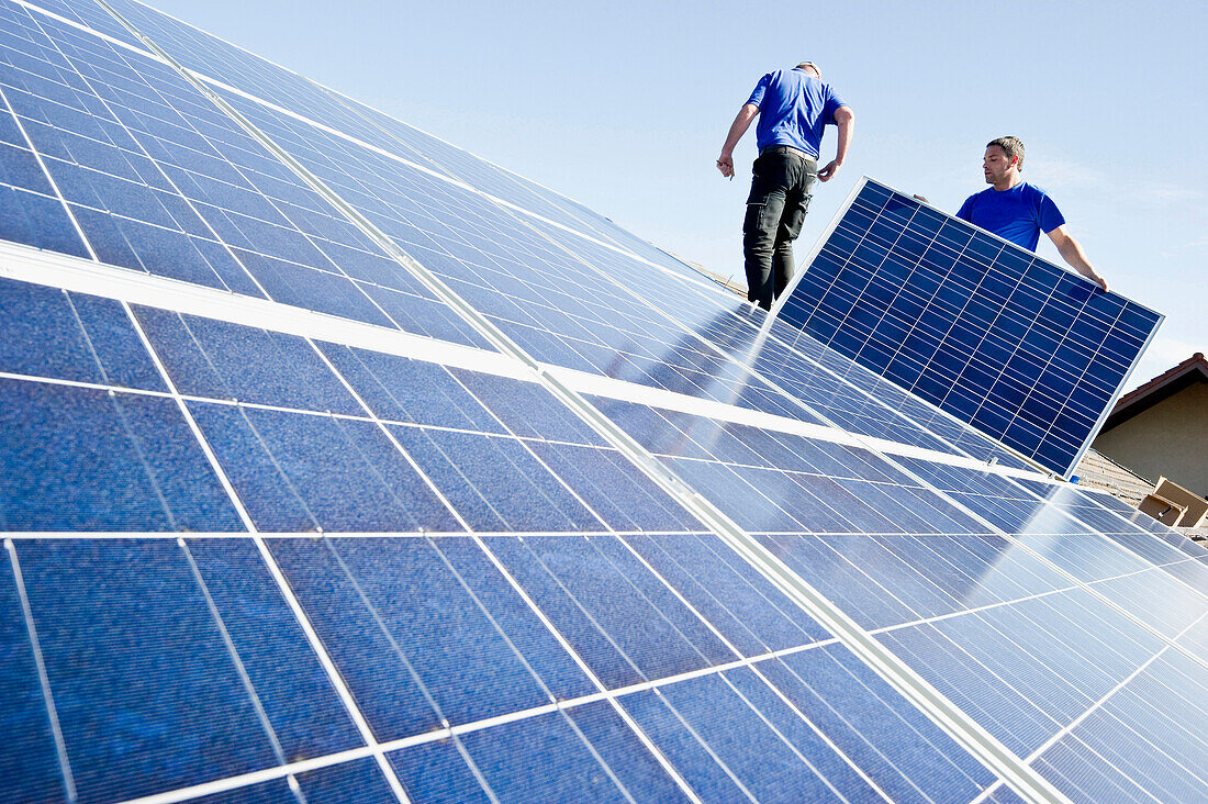 Two persons installing a solar plant, Freiburg im Breisgau, Black Forest, Baden-Wuerttemberg, Germany, Europe