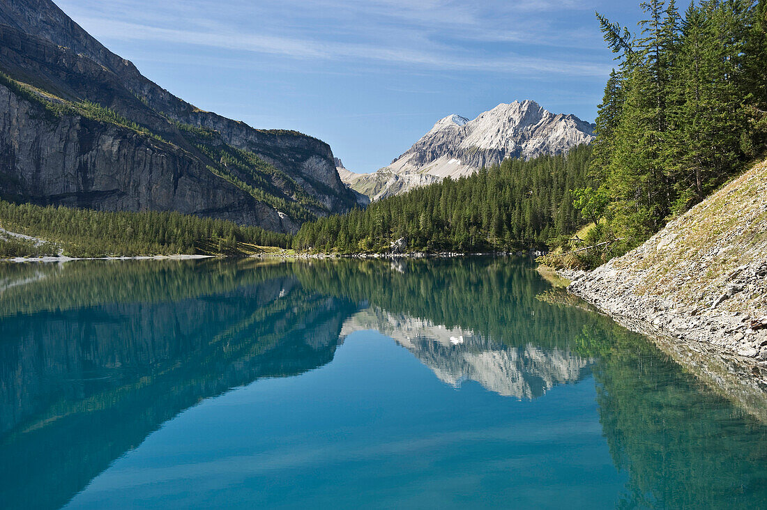 Reflection of mountains on lake Oeschinensee, Kandersteg, Bernese Oberland, Canton of Bern, Switzerland, Europe