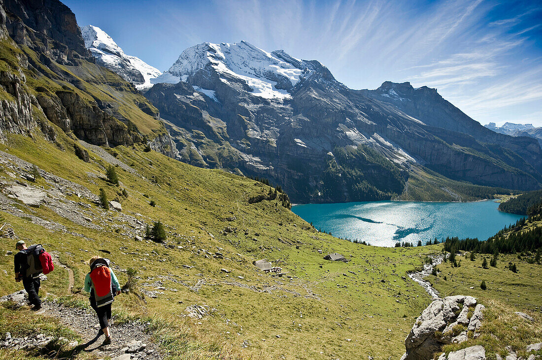 Hikers at lake Oeschinensee, Kandersteg, Bernese Oberland, Canton of Bern, Switzerland, Europe