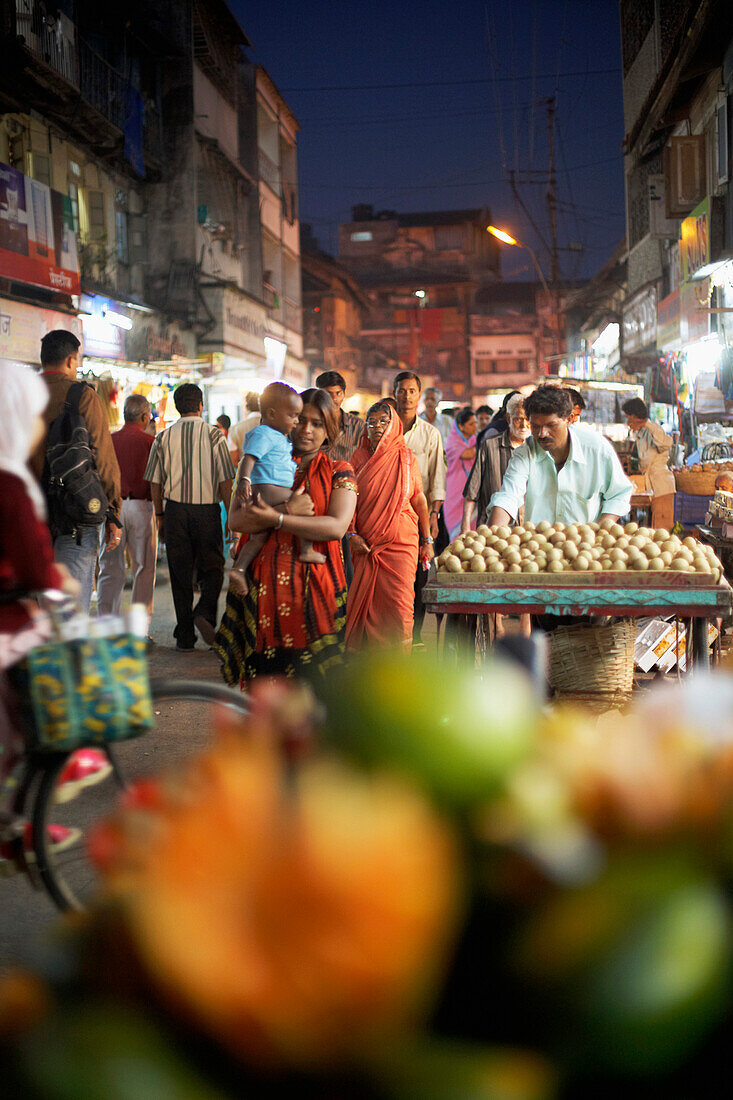 People on the street at a night market in Pune, Maharashtra, India