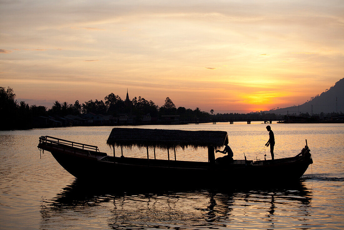 Fishing boat at sunset in Kampot at the Prek Thom River, Kampot province, Cambodia, Asia