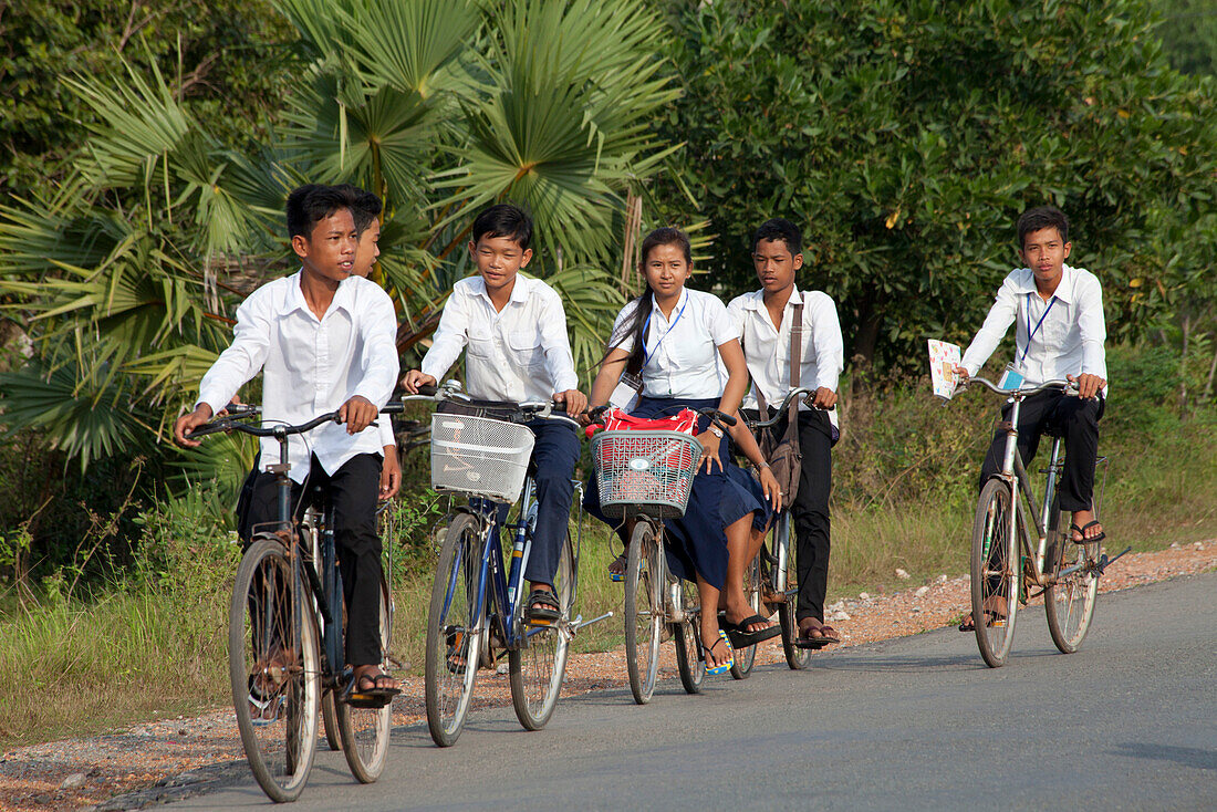 Young pupils on bicycles in the Kampot province, Cambodia, Asia