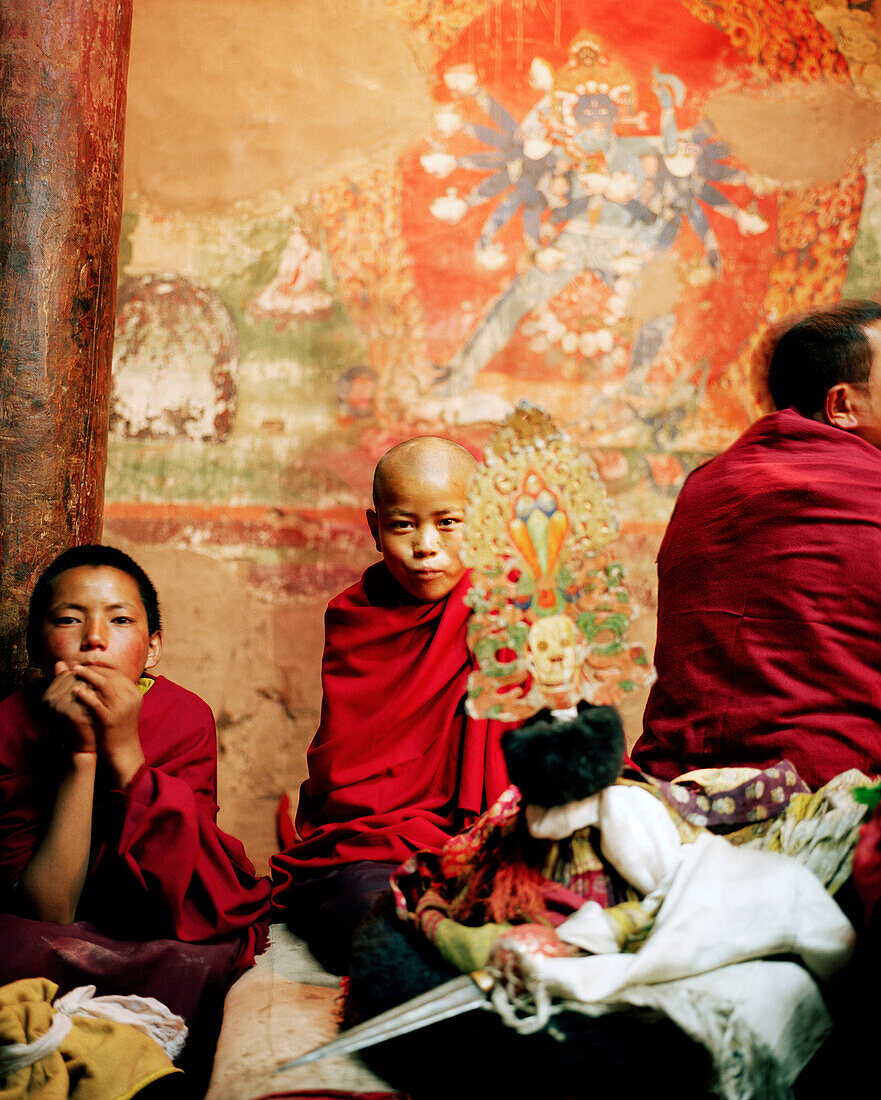 Young monks getting prepared for the dance of masks at the serenity room, during the Hemis Gonpa Festival at convent Hemis, southeast of Leh, Ladakh, Jammu and Kashmir, India