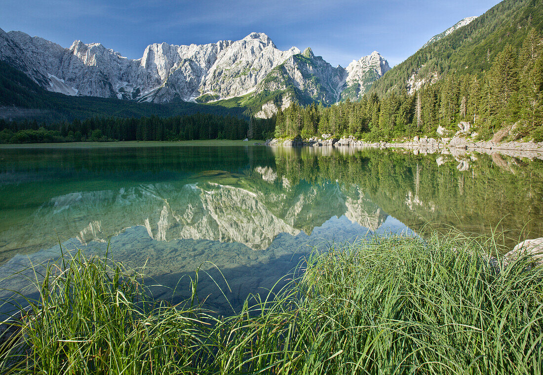 Mangrt Mountain reflected in lake at Lagi di Fusine, Julian Alps, Italy