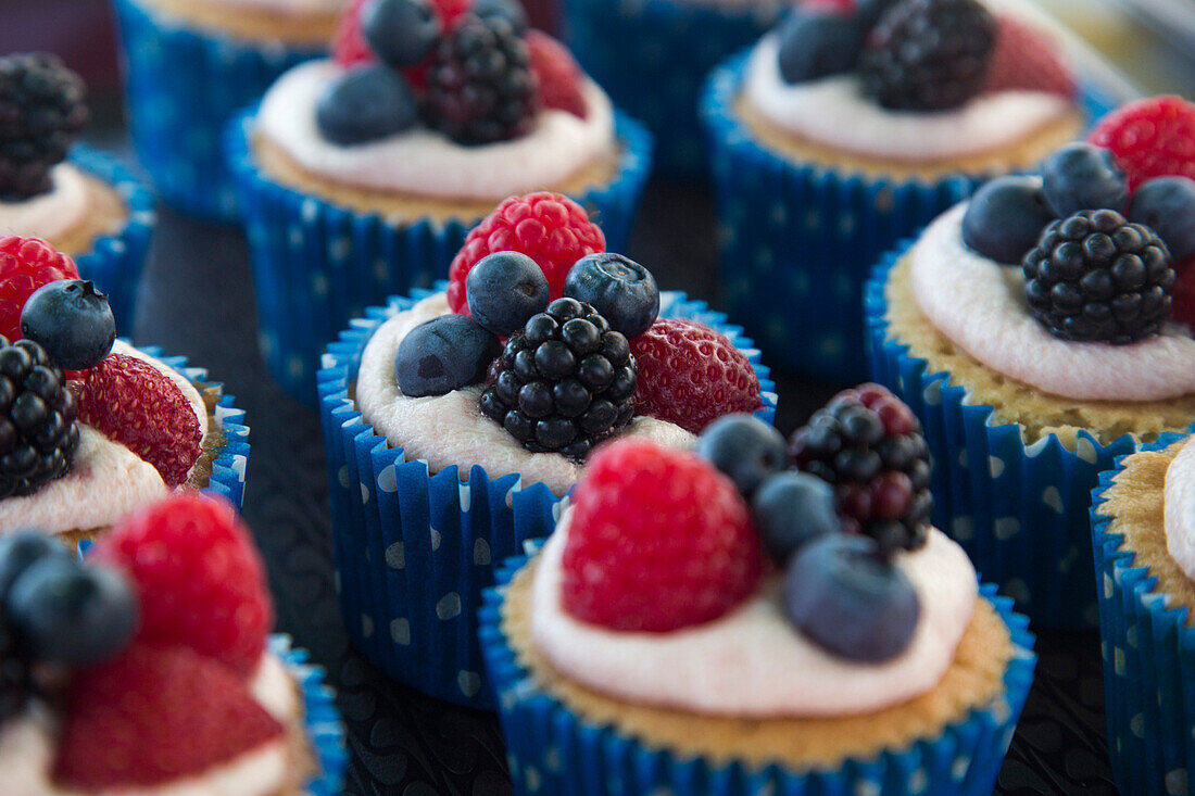 Beautiful berry cupcakes for sale at market stall, St Peter Port, Guernsey, Channel Islands, England, British Crown Dependencies