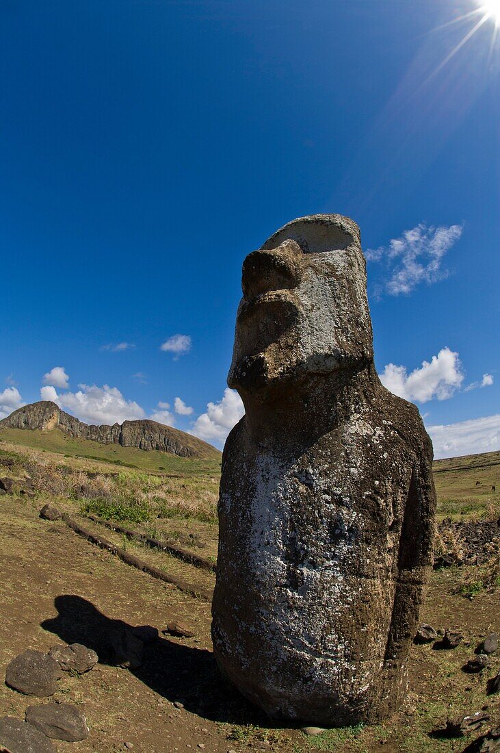 Moai at the entrance to the Ahu Tongariki site on Easter Island, with view of Rano Raku in the distance