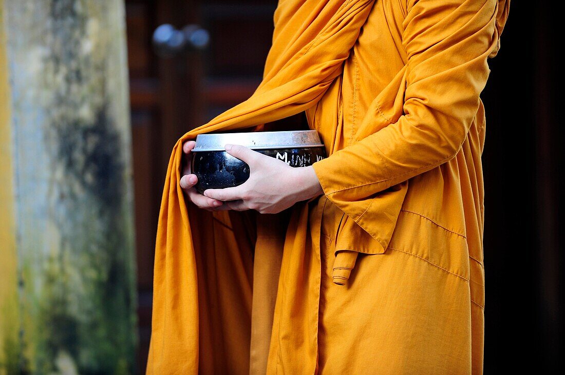 Asia,South East Asia,Vietnam,close-up of hands of a monk holding a bowl