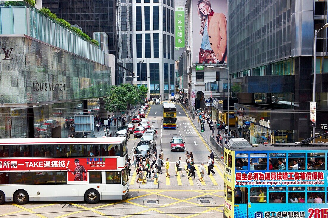 Cars, taxis, buses and people in congested traffic in central Hong Kong