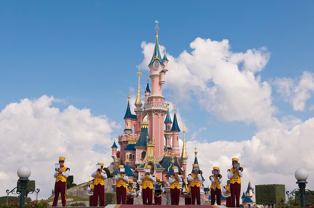 A band playing in front of the Sleeping Beauty Castle at Disneyland Paris in France