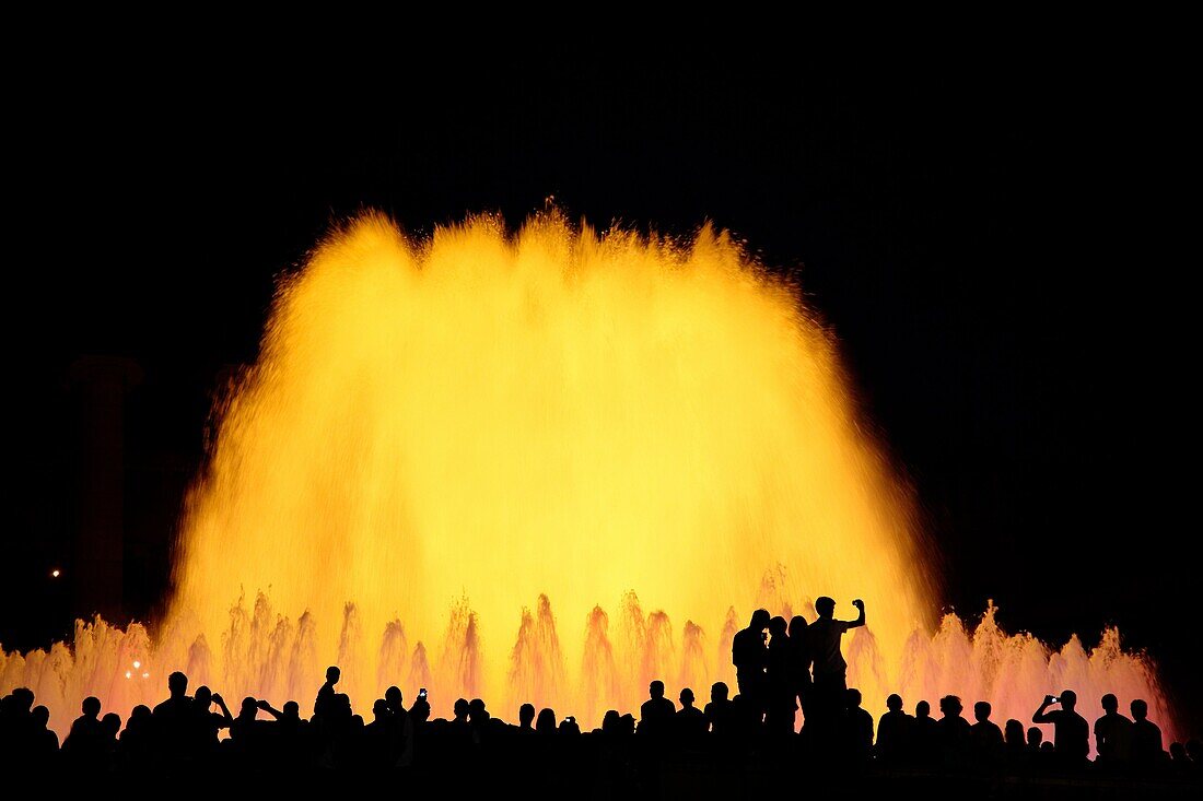 Tourists enjoying the light show of the Plaza de Espana in Barcelona, Catalonia, Spain