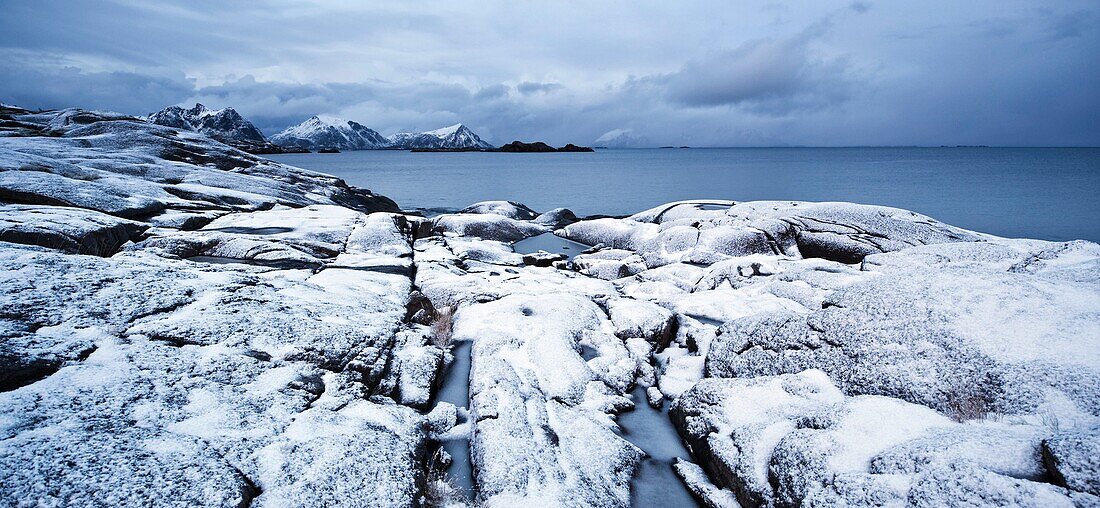 Snow covered rocky coastline at Stamsund, Vestvågøy, Lofoten islands, Norway