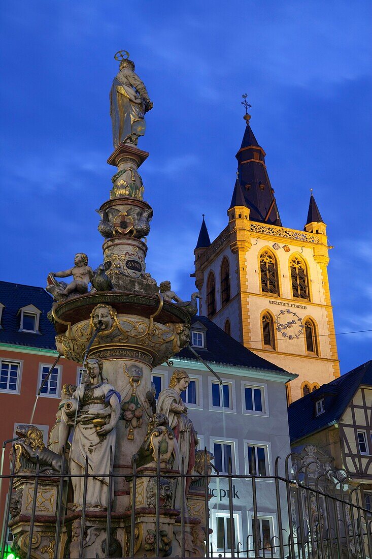 market place with fountain and church St  Gangolf, illuminated at night, Trier, Germany