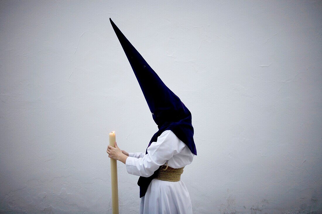 A penitent holds a candle during an Easter Holy Week procession in Carmona village, Seville province, Andalusia, Spain, April 19, 2011