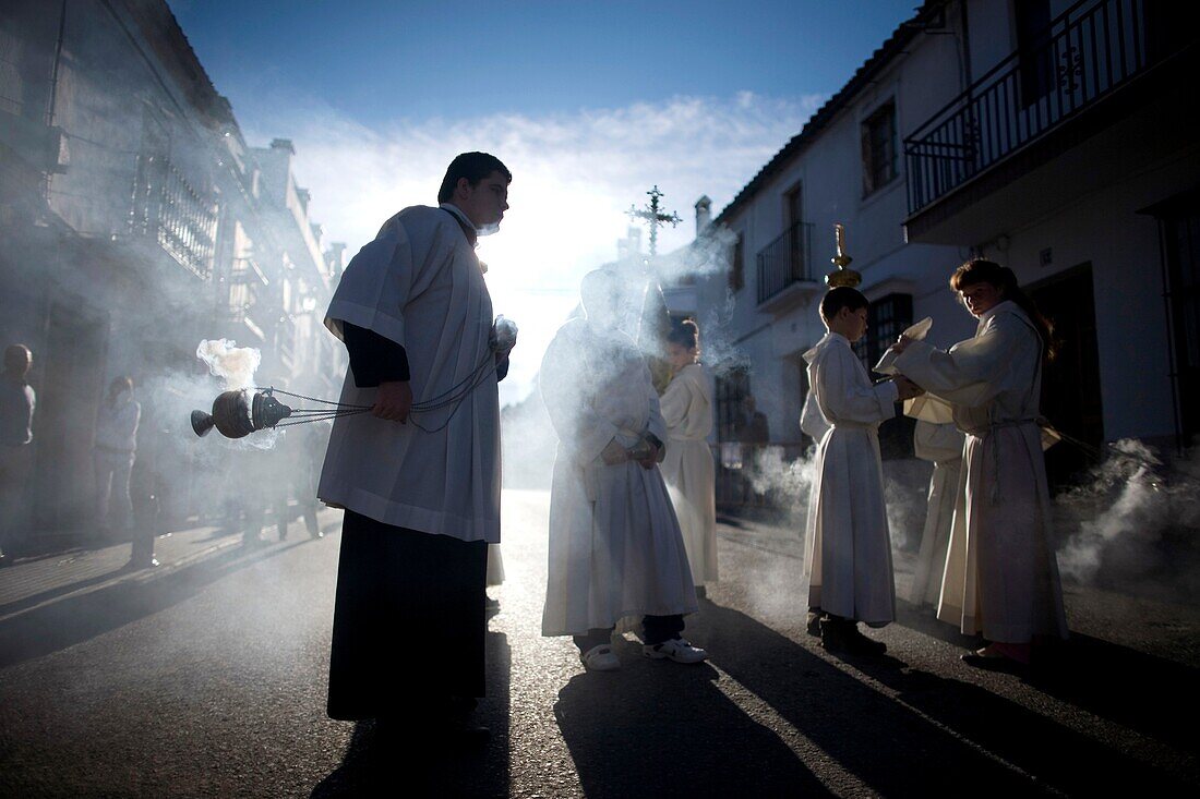 An acolyte spreads incense during an Easter Holy Week procession in Prado del Rey, Andalusia, Spain, April 24, 2011