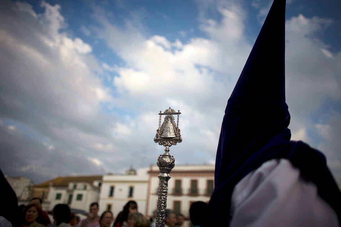 A penitent holds a metal ceremonial staff decorated with a Virgin Mary image during an Easter Holy Week procession in Carmona village, Seville province, Andalusia, Spain, April 20, 2011