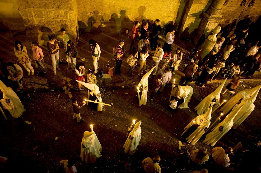 Penitents walk in a street during an Easter Holy Week procession in Cordoba, Andalusia, Spain, April 17, 2011
