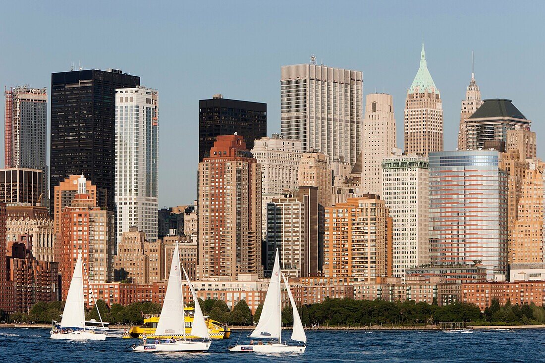 Sailboats on the Hudson River, with the lower Manhattan financial district of New York City as a backdrop, as seen from Liberty State Park, New Jersey, USA