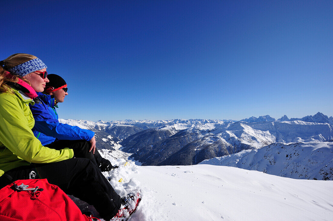 Young woman and young man resting at mount Kreuzspitze, East Tyrol, Tyrol, Austria