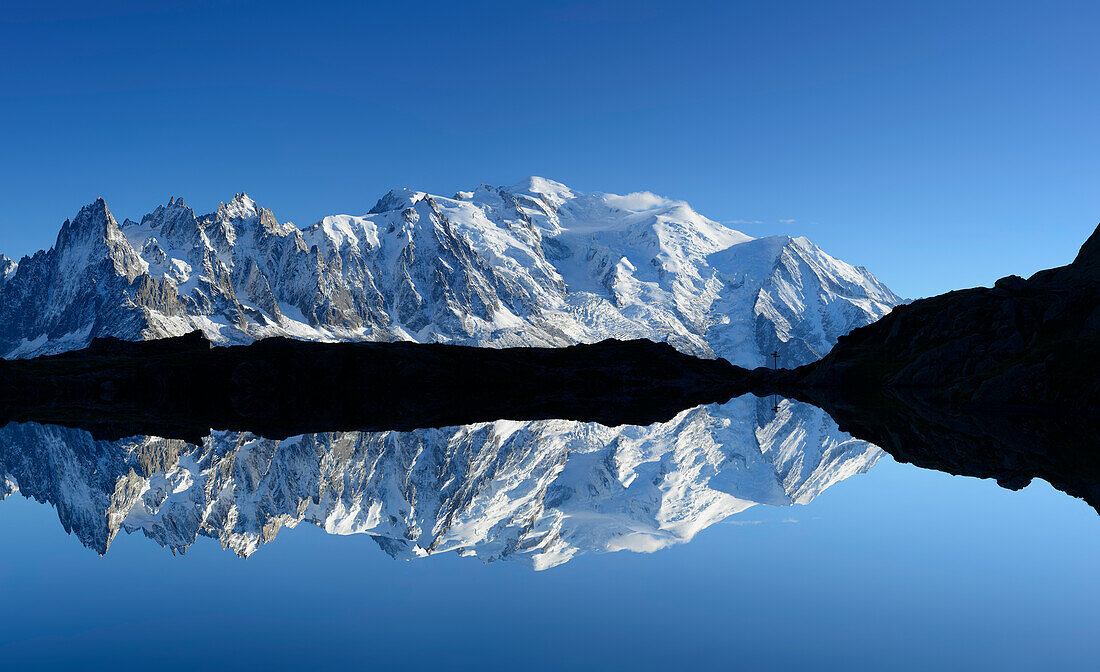 Panorama of Mont Blanc range reflecting in a mountain lake, Mont Blanc range, Chamonix, Savoy, France