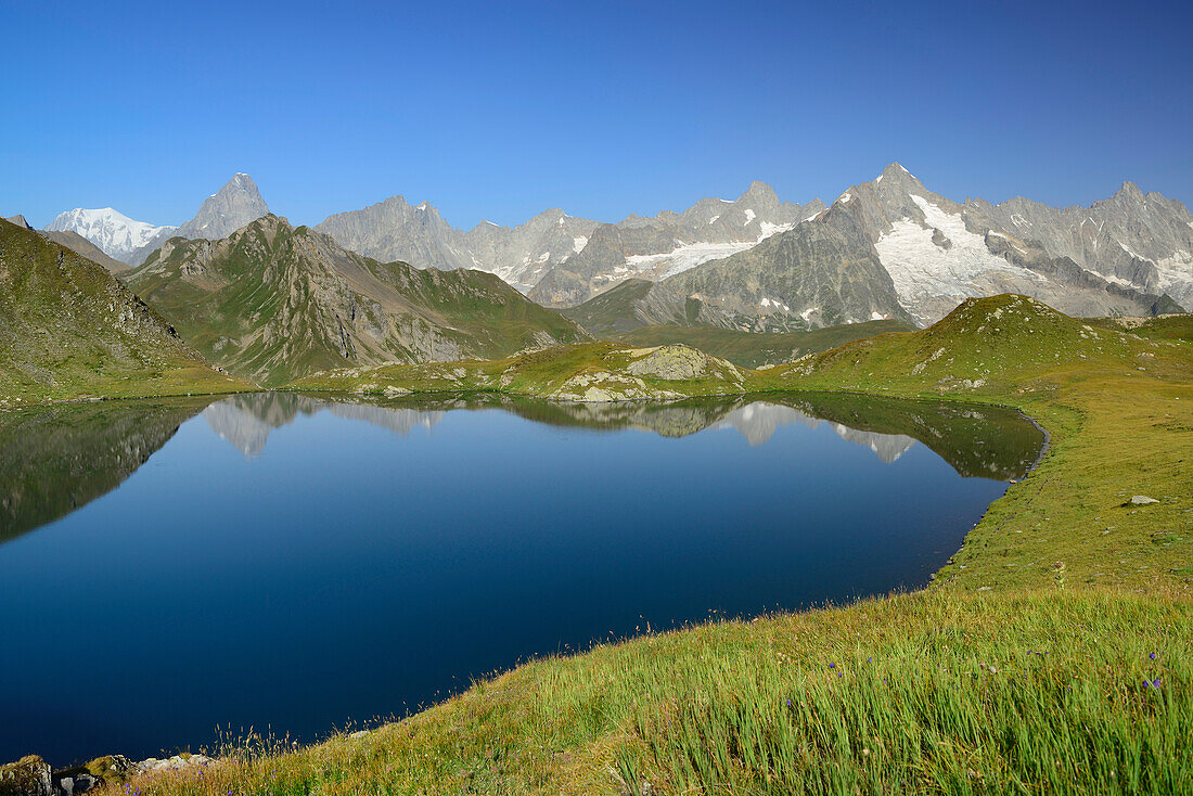 Mont Blanc range with Mont Blanc, Grandes Jorasses and Mont Dolent reflecting in a mountain lake, Pennine Alps, Aosta valley, Italy
