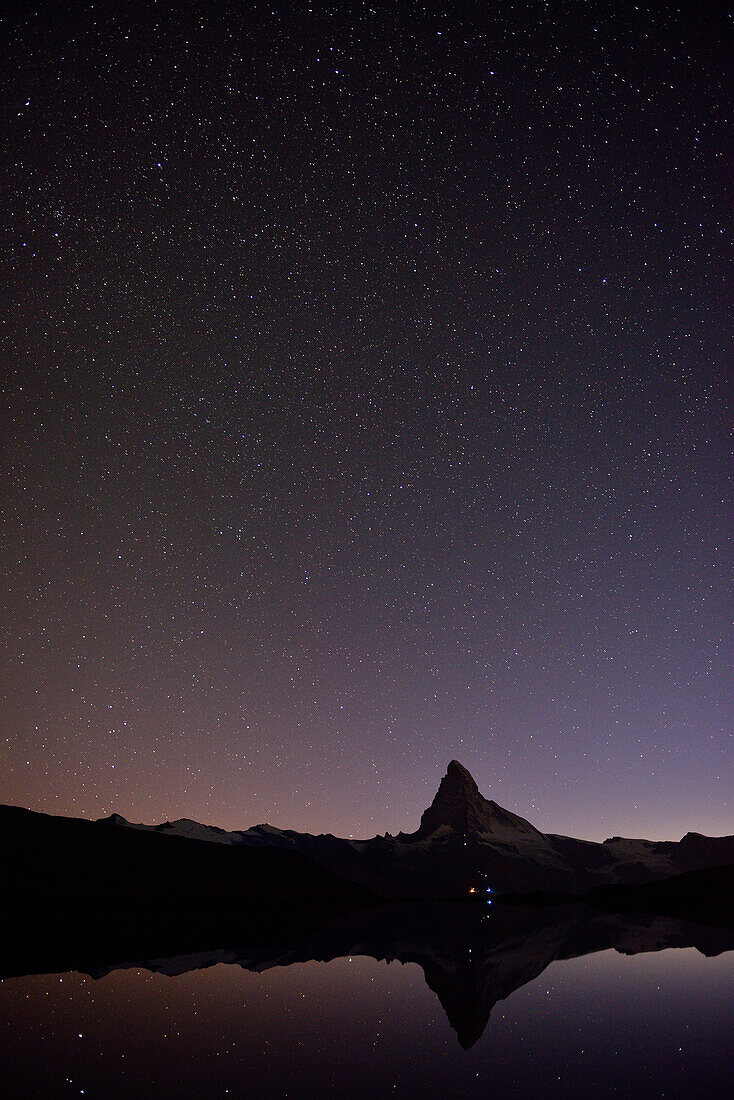 Silhouette of the Matterhorn reflecting in a mountain lake, Pennine Alps, Valais, Switzerland