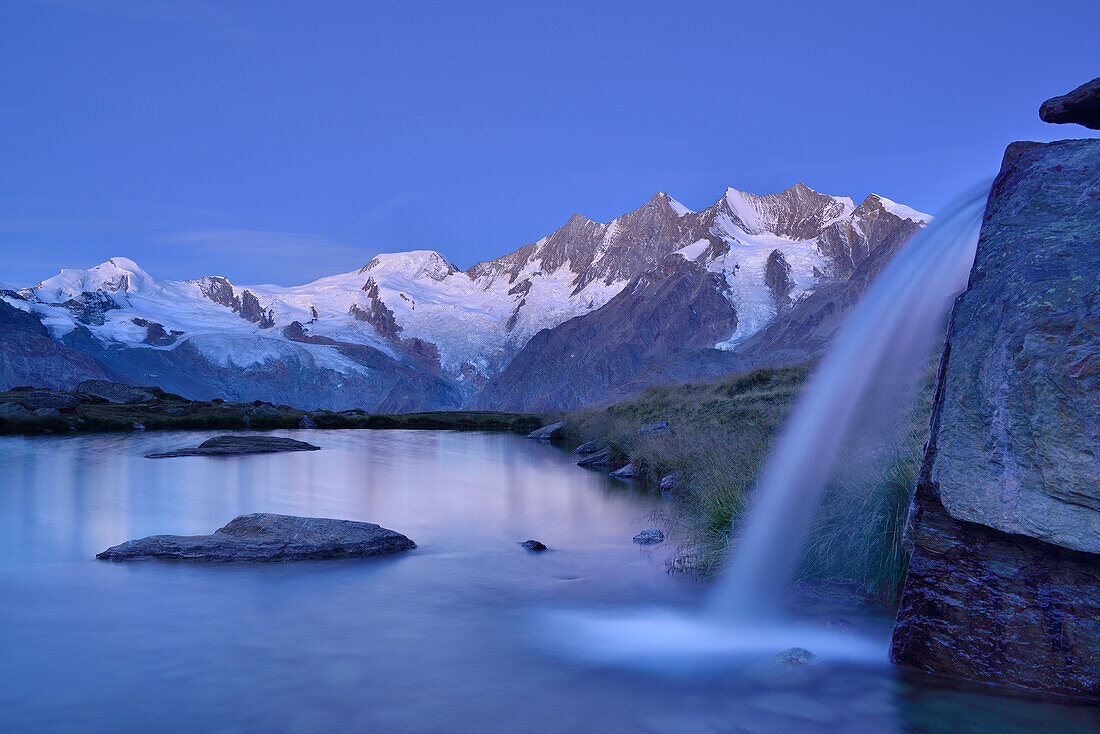 Mischabel range with Allalinhorn, Alphubel, Täschhorn, Dom and Lenzspitze reflecting in a mountain lake, Pennine Alps, Valais, Switzerland