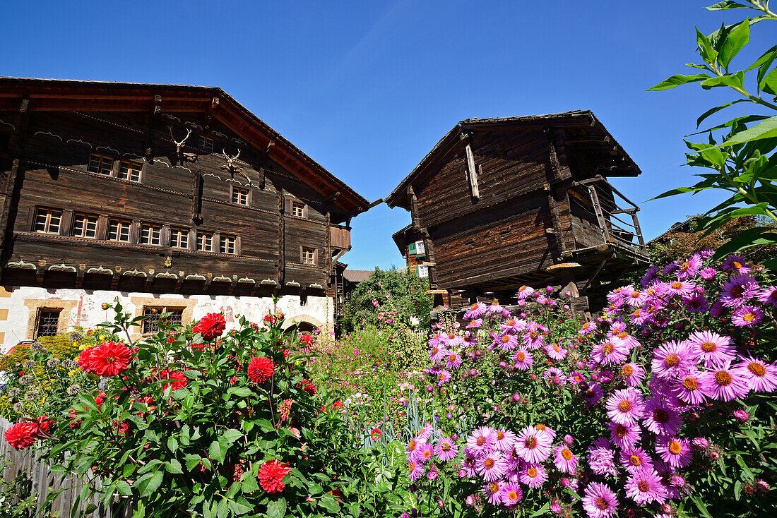 Garden and traditional wooden house, Valais, Switzerland