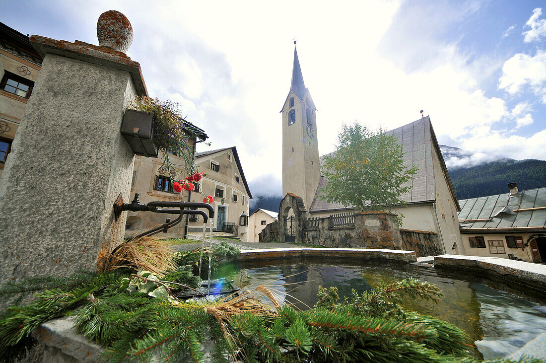 Fountain in front of the church of Guarda, Lower Engadine, Grisons, Switzerland, Europe