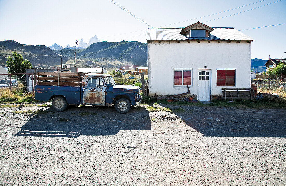 Old truck near a house, El Chalten, Fitz Roy in background, Santa Cruz, Patagonia, Argentina