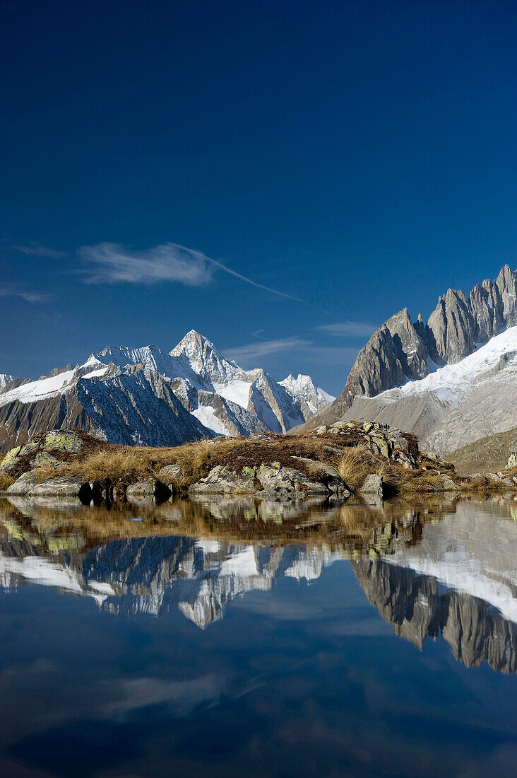 Reflection on lake Bettmersee, Bettmeralp, in the background Bernese Oberland, Canton of Valais, Switzerland, Europe