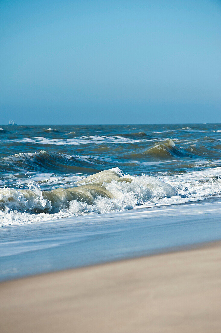 Sandy beach and waves on the island of Sylt, Schleswig-Holstein, Germany